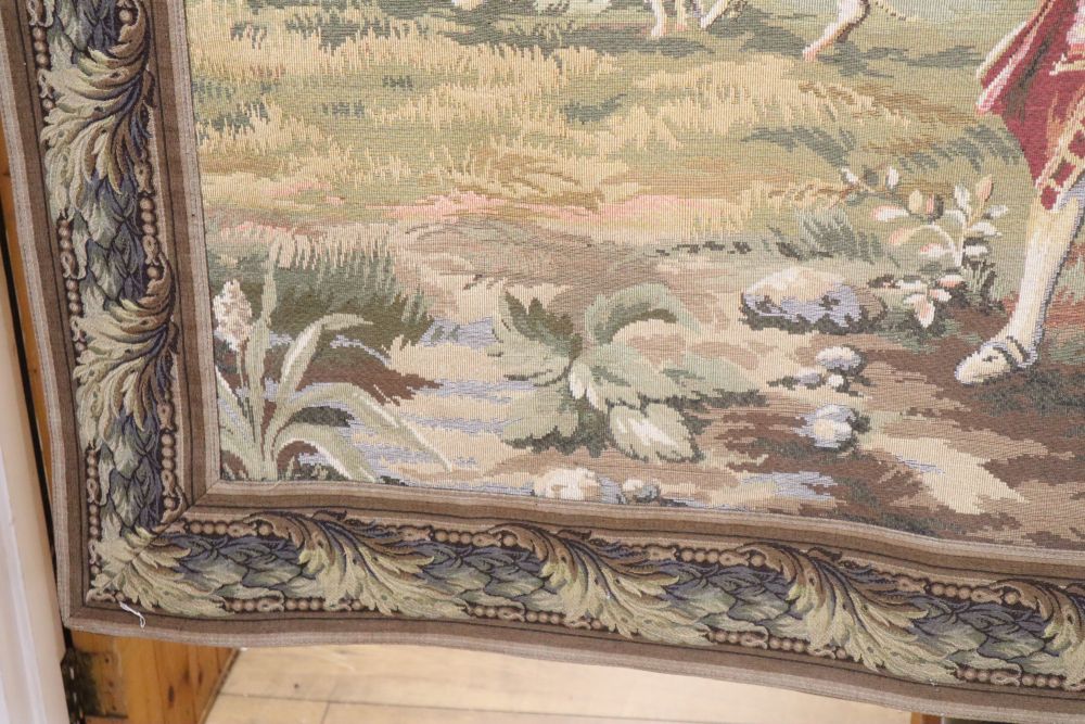 An Aubusson style machine woven hanging tapestry depicting a hunting party, with pole